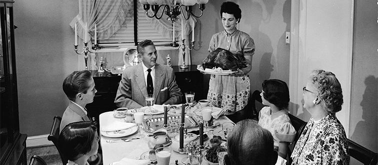 a family sitting at the dinner table