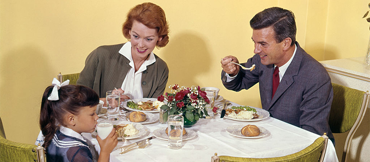 a family eating dinner at the table