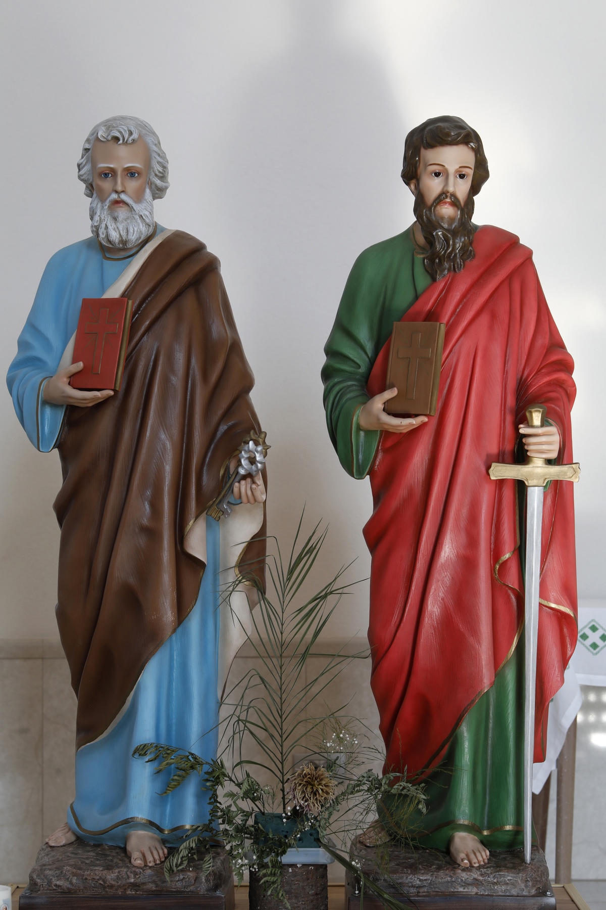 Statues of St. Peter and St. Paul stand in a Catholic church.