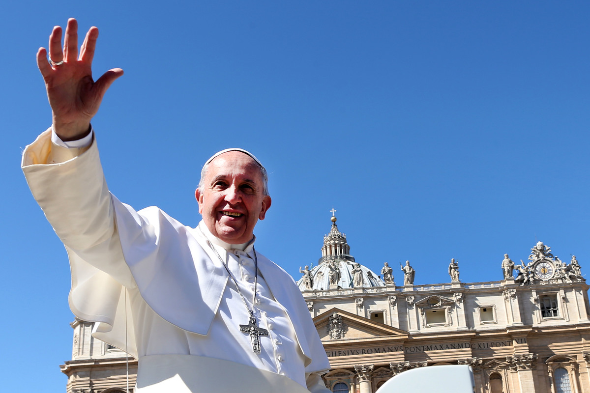 Pope Francis waves to the faithful as he leaves St. Peter's Square.