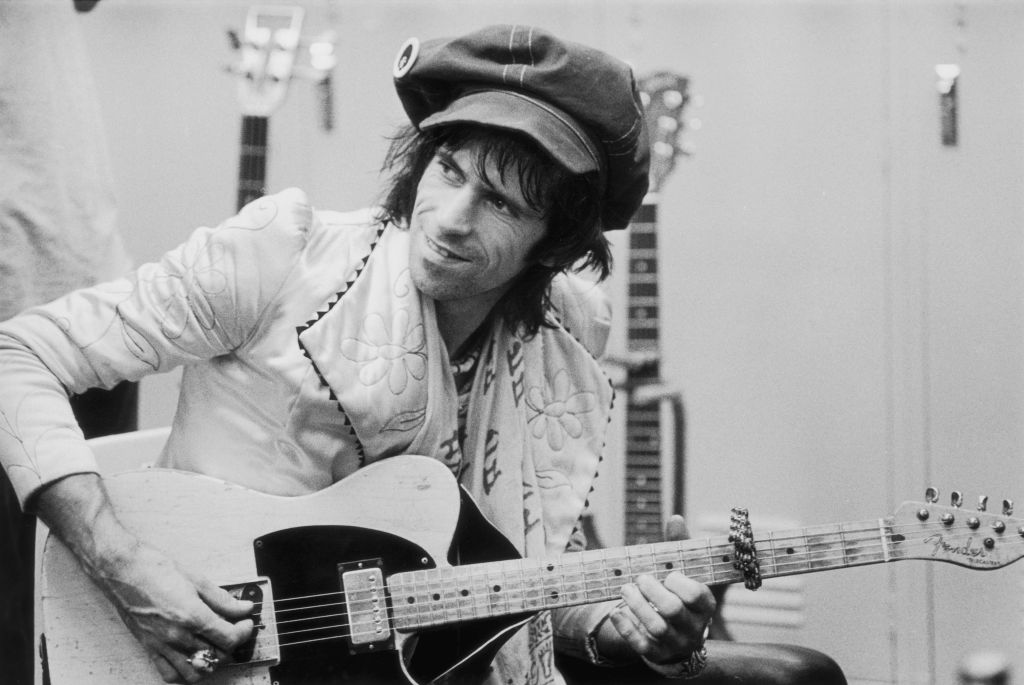 Keith Richards plays guitar backstage.