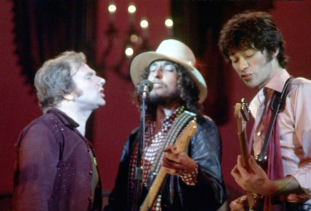 Van Morrison, Bob Dylan and Robbie Robertson performing on stage