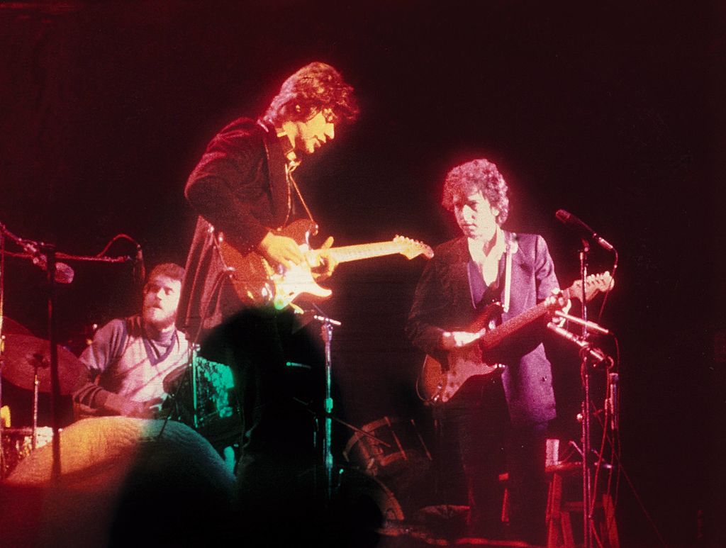 (L-R) Levon Helm, Robbie Robertson and Bob Dylan performing on stage