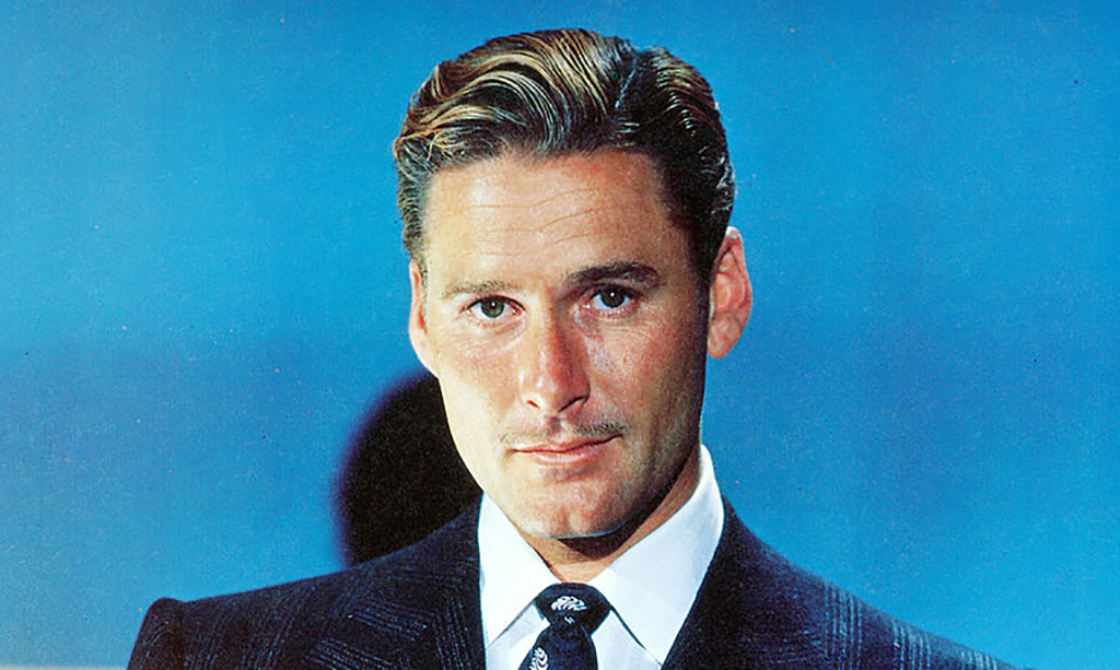 Errol Flynn in front of blue background 