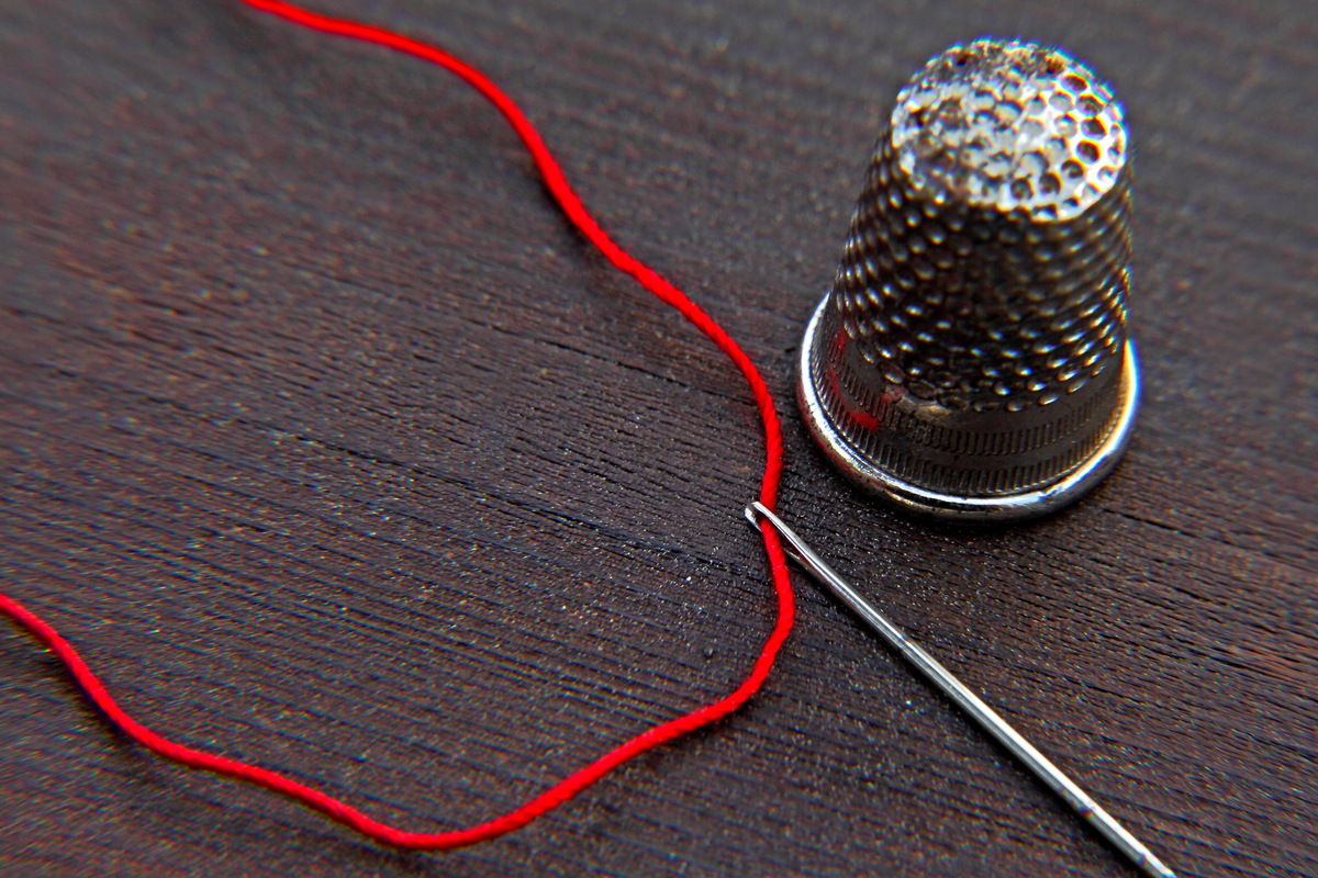 thimble with needle and thread