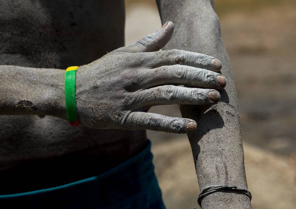 Man touching his skin 