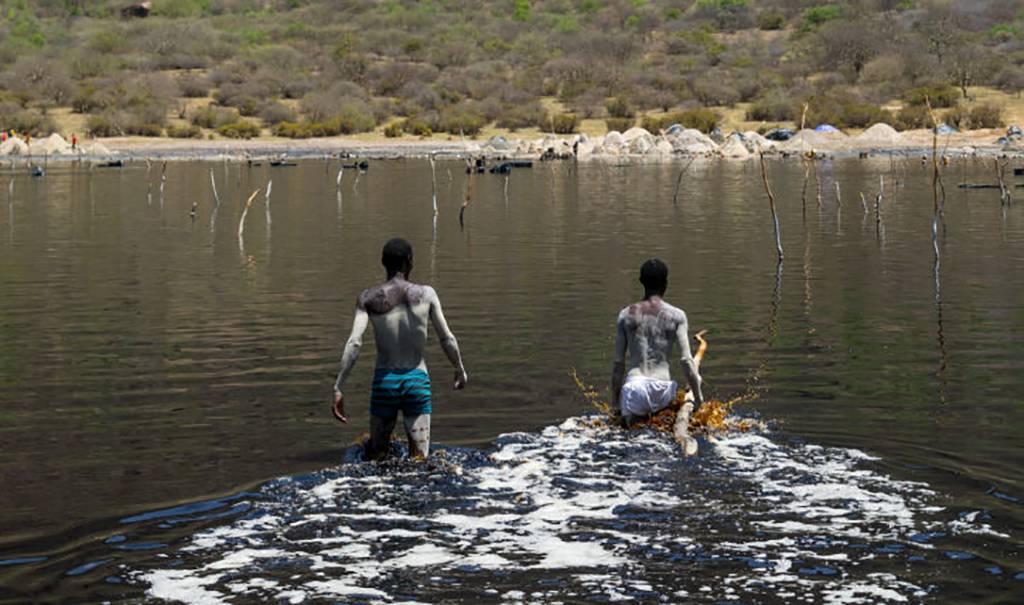 Men walking into lake 