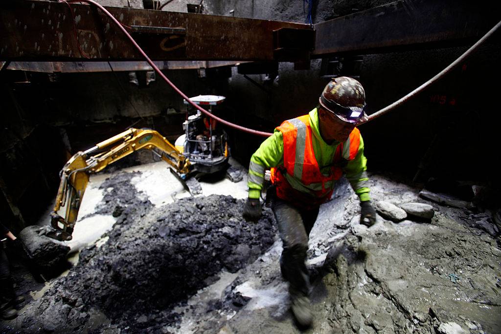 A construction worker walks through some of the debris