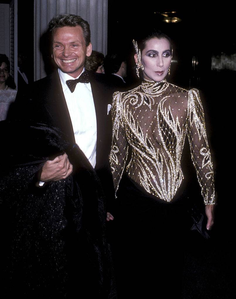 Cher attends an art show with fashion designer Bob Mackie.