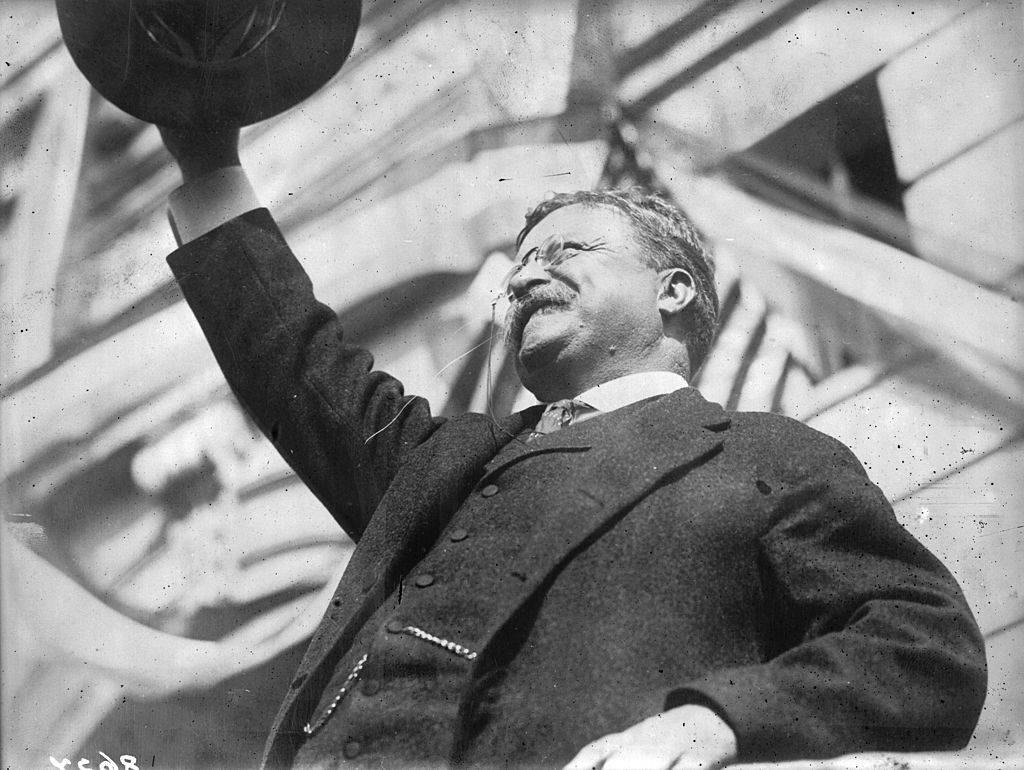 Roosevelt waving his hat 