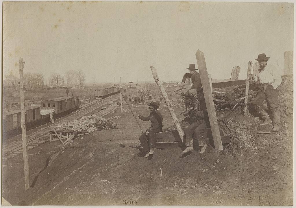 Men sitting by a railroad 