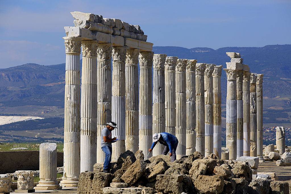 Men looking through the rubble