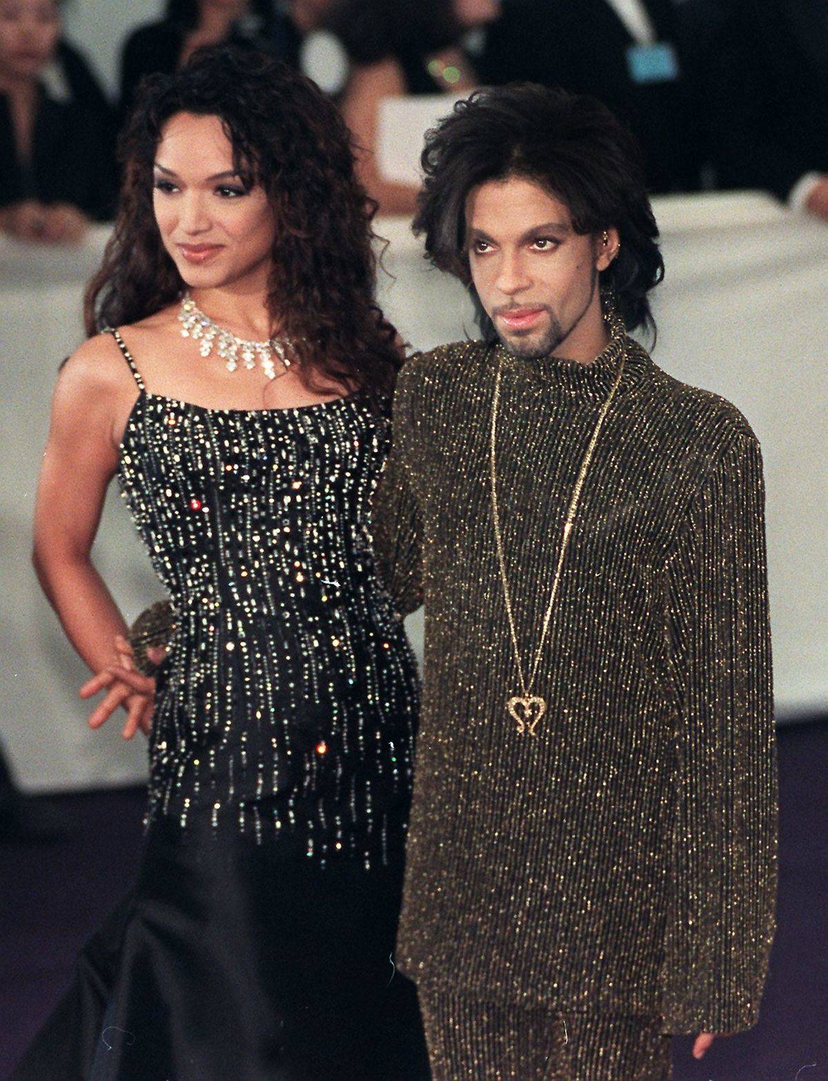 Prince poses for photographers with his wife Mayte in 1999.