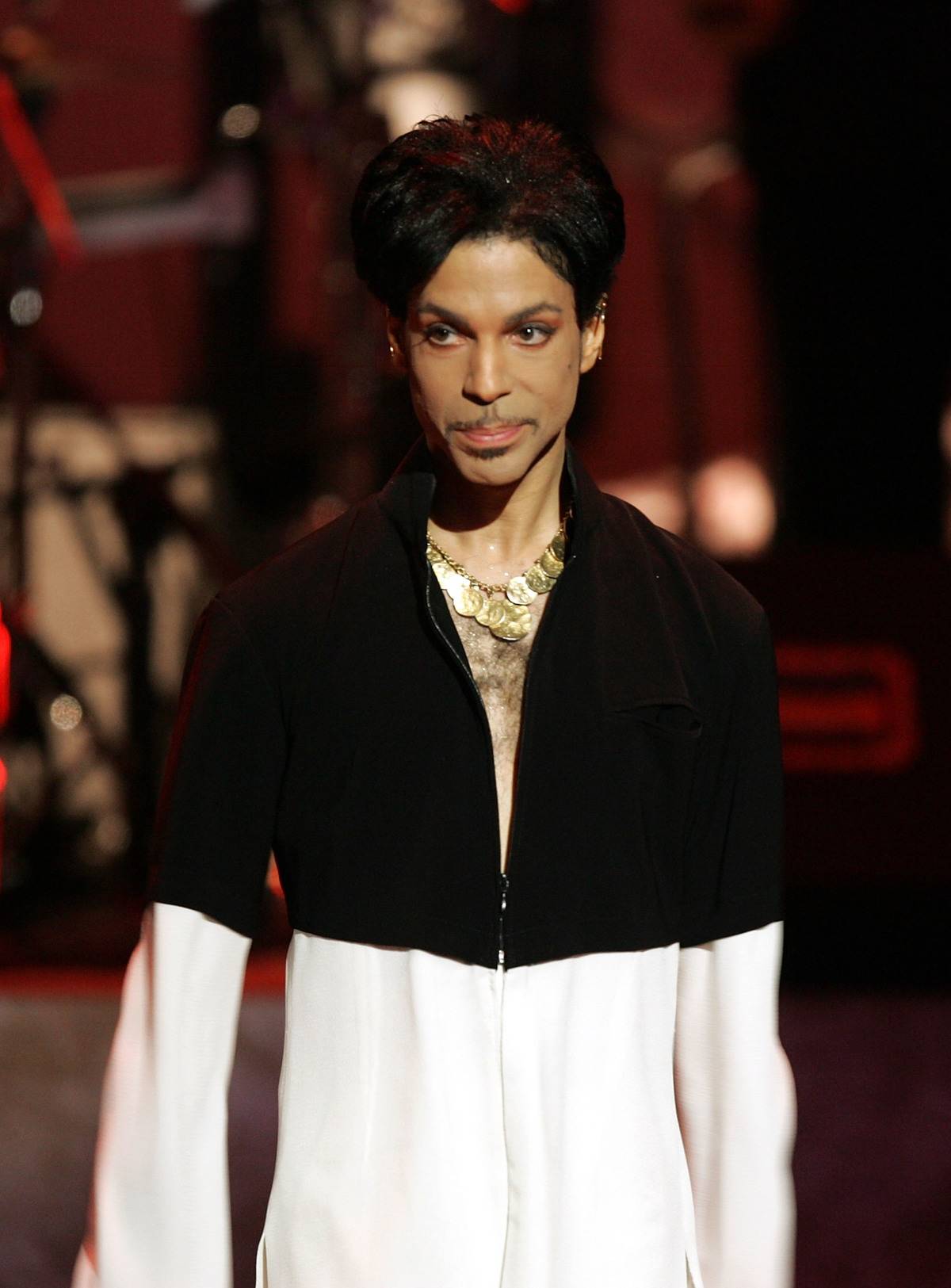 The musician Prince walks on stage to receive an award.