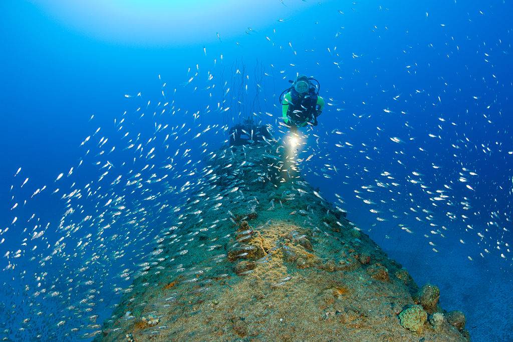 Man underwater with submarine