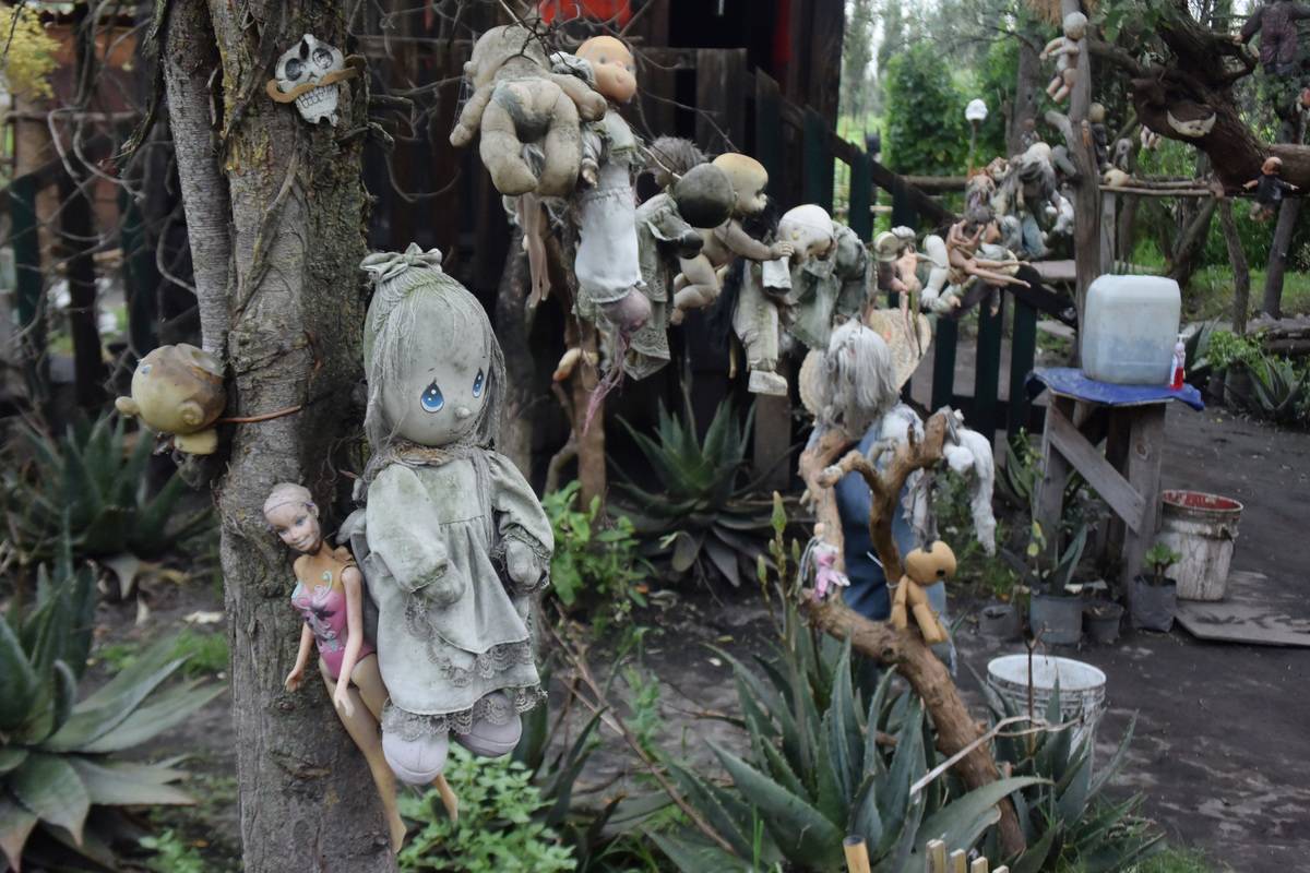 dolls hanging on trees and cabins