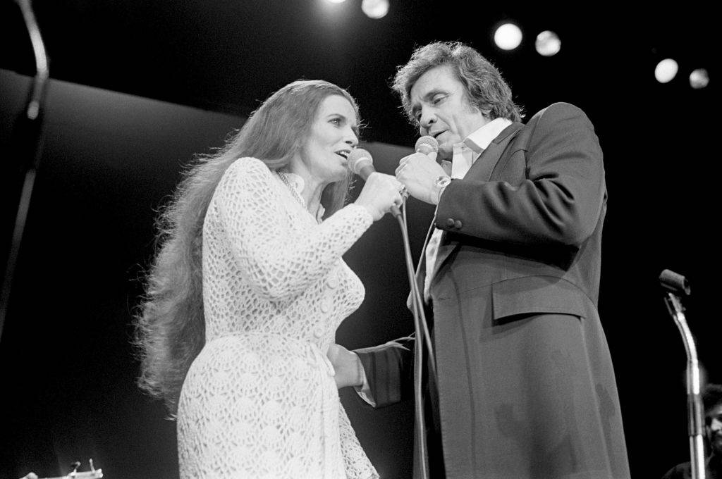 Johnny and June face towards each other while they duet onstage.