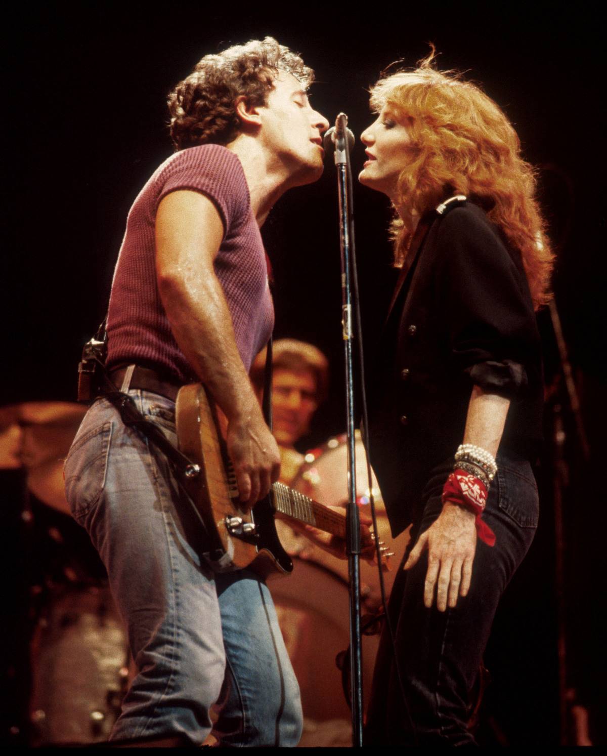 Bruce and Patti face one another while performing.