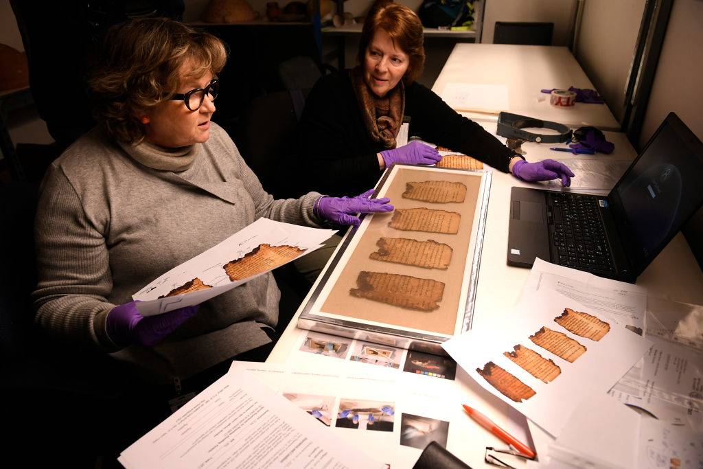 Women studying the scrolls