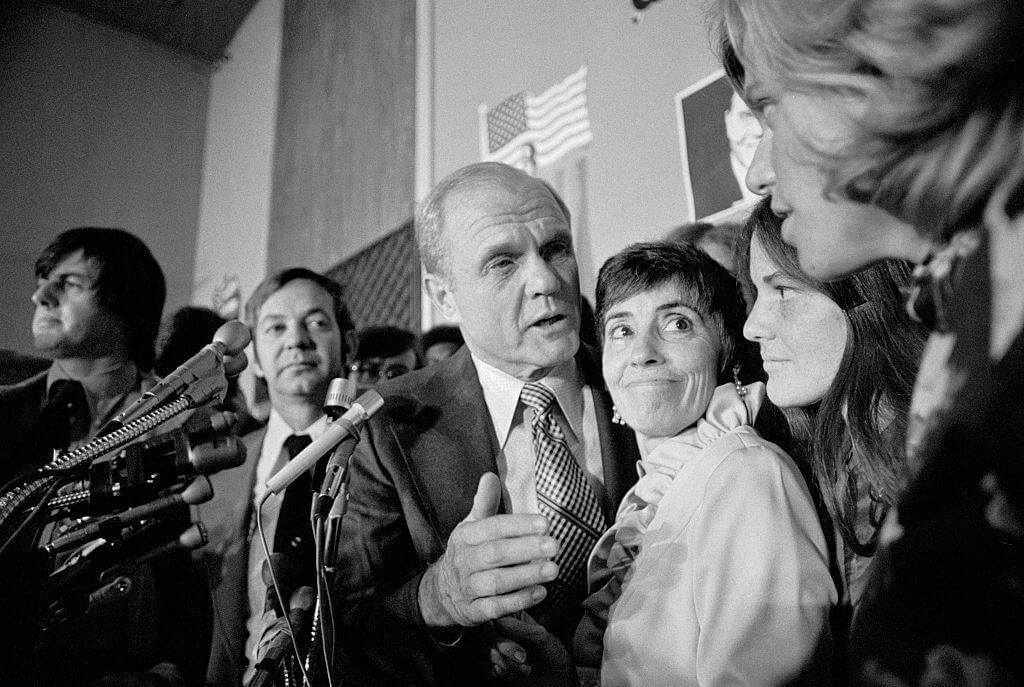 Former astronaut John Glenn accepts congratulations as his wife, Annie and daughter, Lynn (R), look on