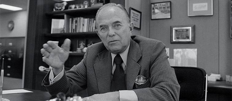 a black and white photo of Ray Kroc