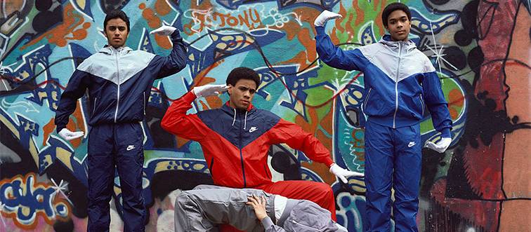 breakdancers in front of graffiti