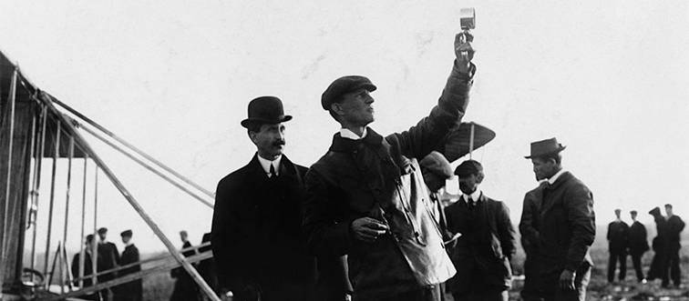 wilbur and orville wright standing outside