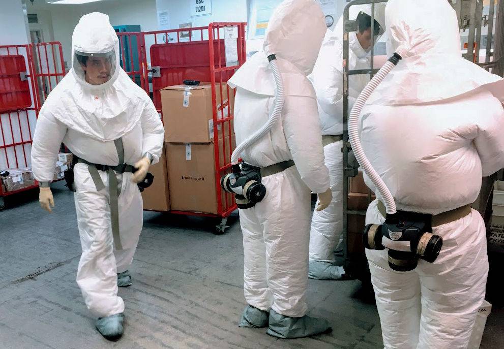 men in hazmat suits