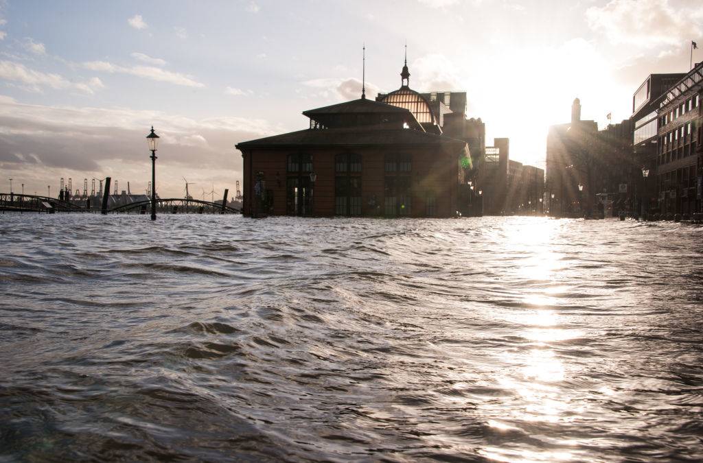 The fish market with the fish auction hall on the Elbe is flooded during a storm tide.