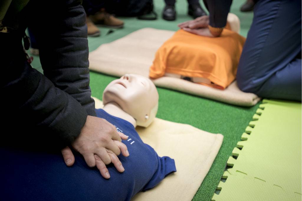 Foreign residents are told how to do a cardiac massage during the Disaster Preparedness Drill for Foreign Residents in FY2018 in Komazawa Olympic Park General Sports Ground in Tokyo, January 25, 2018, Japan