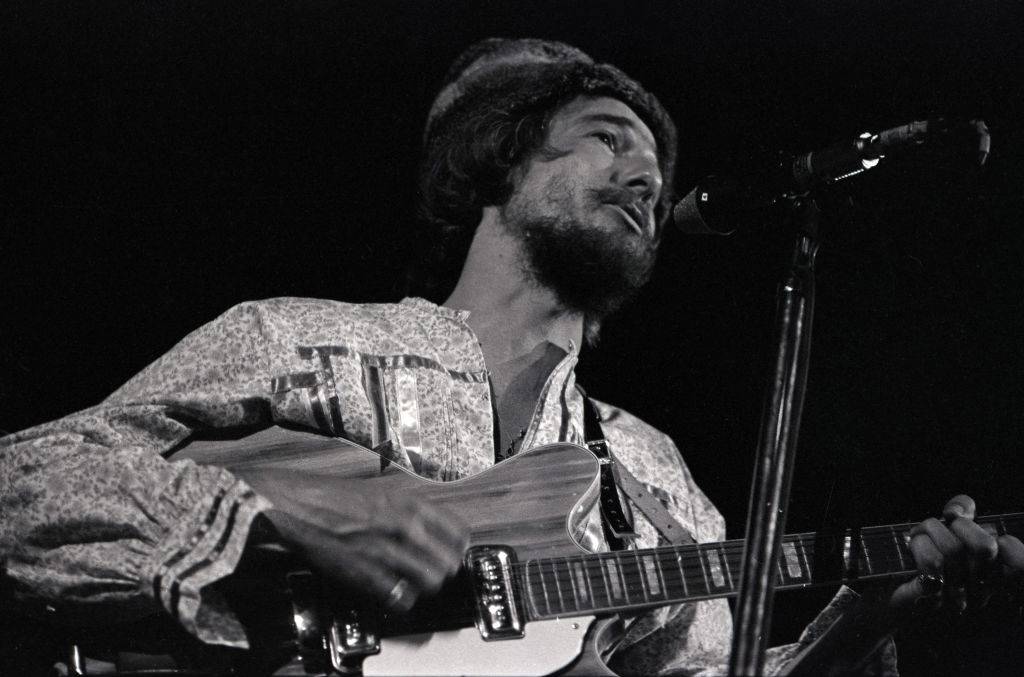 John playing the guitar