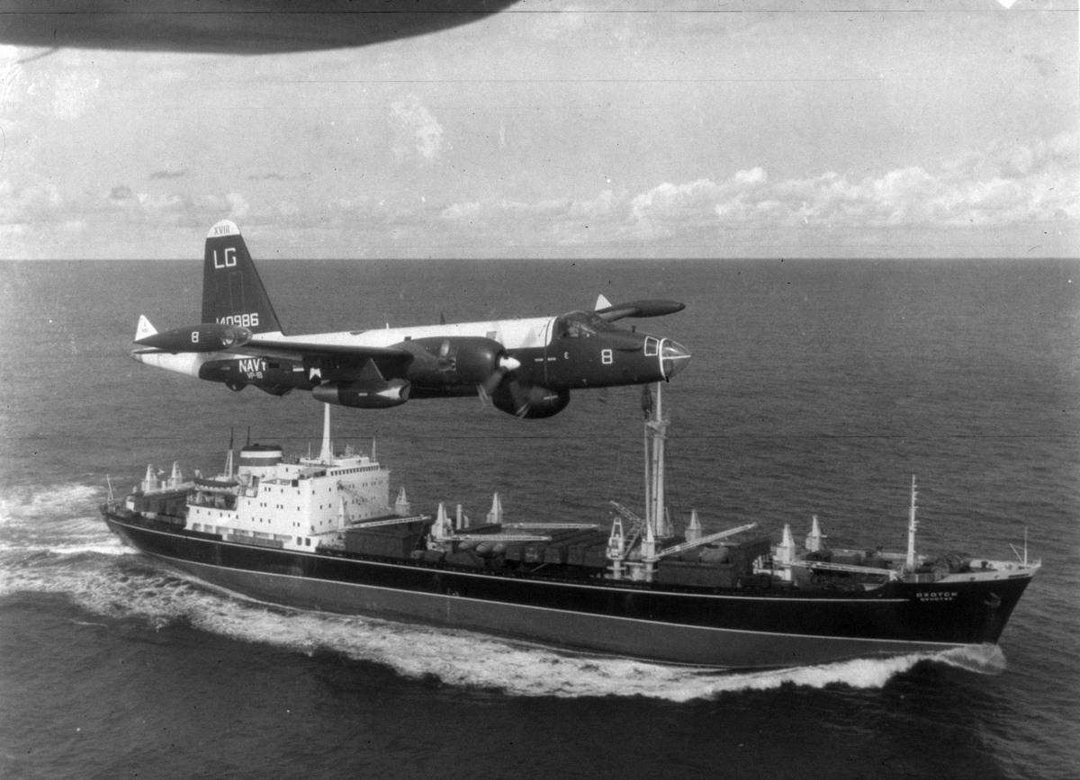 An American patrol plane flies over a ship during the Cuban missile Crisis.