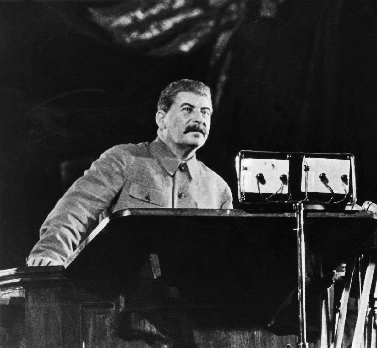 Joseph Stalin addresses voters at a podium.