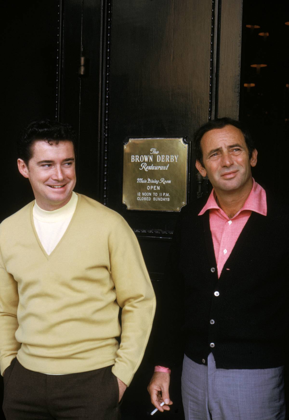 Regis Philbin and Joey Bishop stand outside the famous Brown Derby Restaurant.