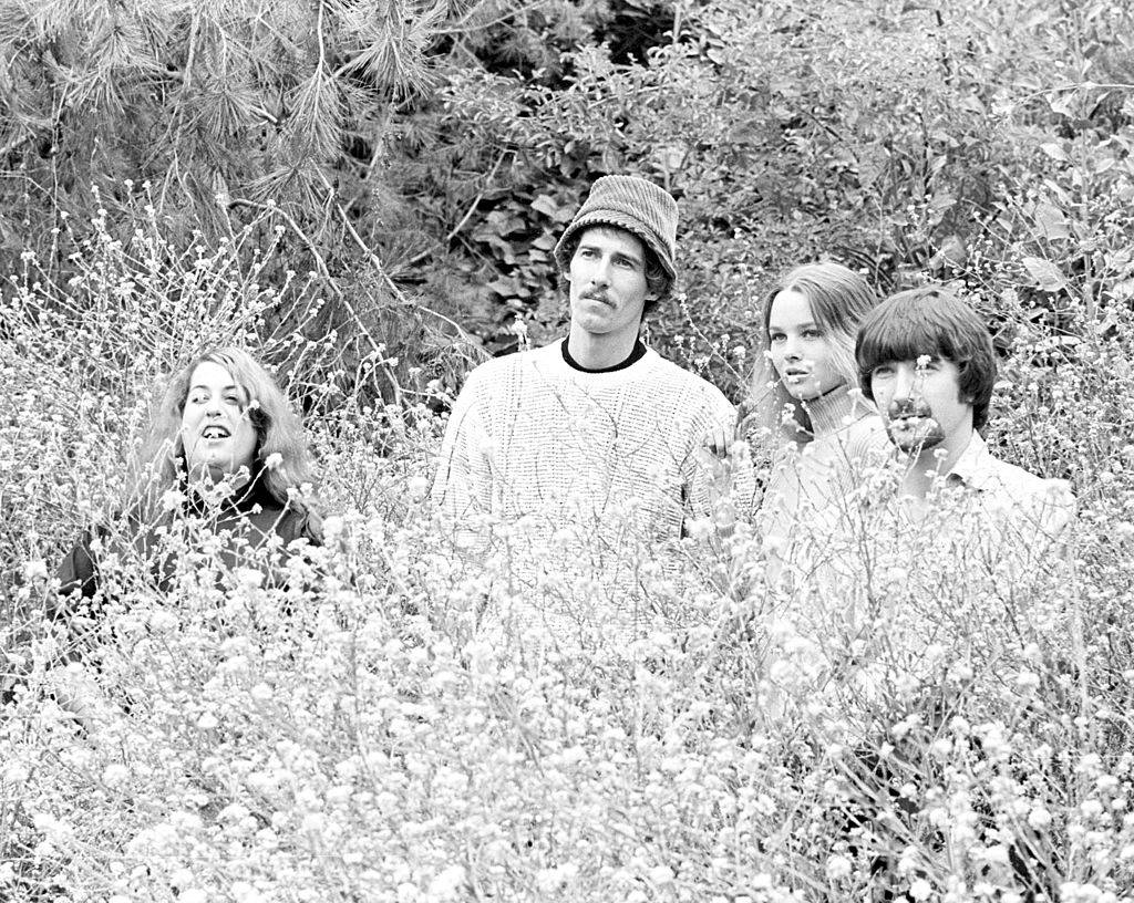 The band standing in flowers