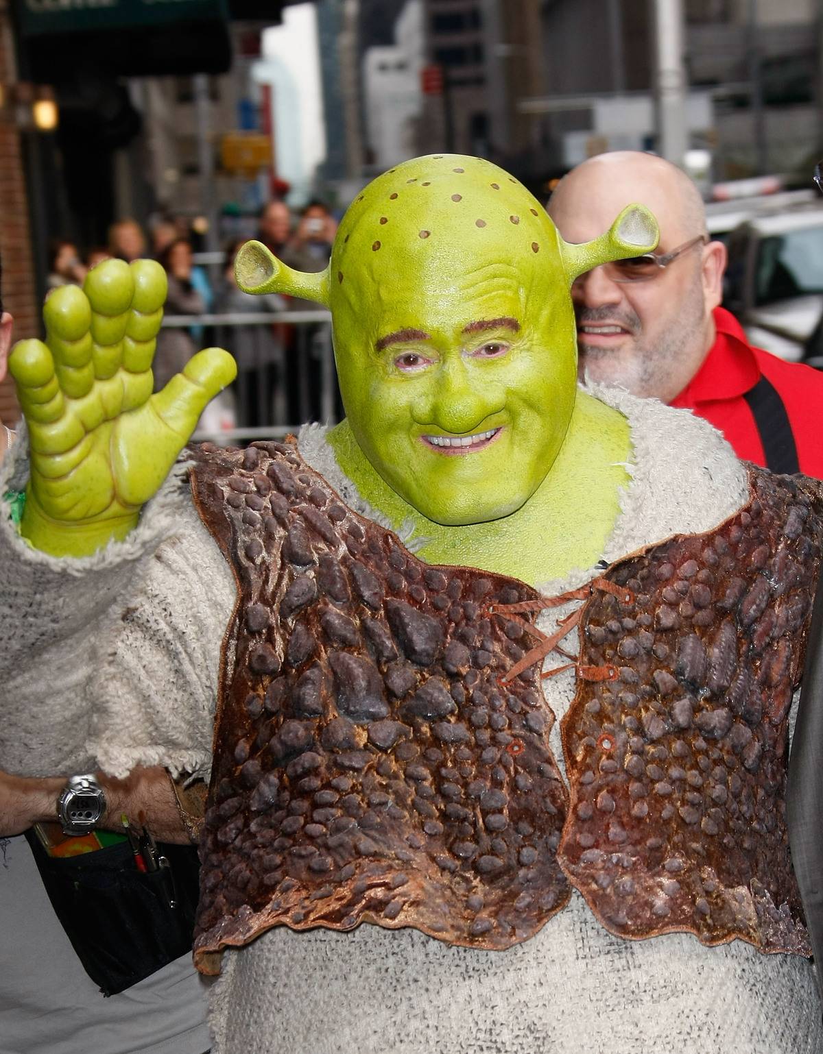 Television personality Regis Philbin is dressed as Shrek.