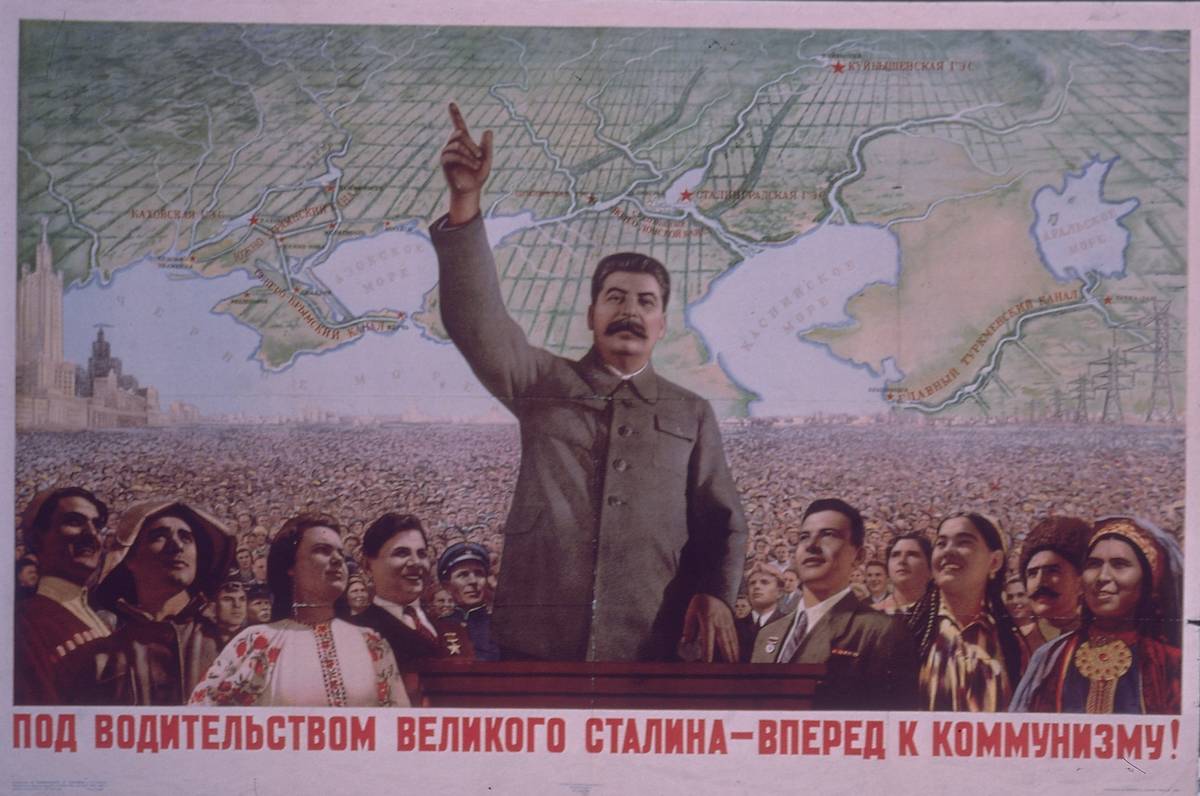 A poster of Joseph Stalin shows him with his hand raised.