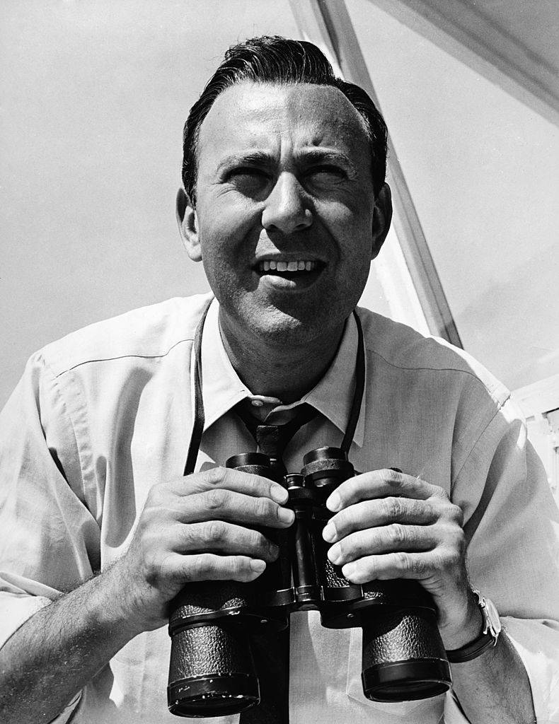 Portrait of American actor, film director and producer holding binoculars, circa 1955.
