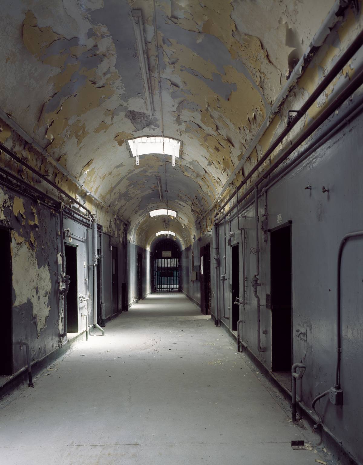 Hallway with crumbling plaster at the abandoned Eastern State Penitentiary, Philadelphia, Pennsylvania
