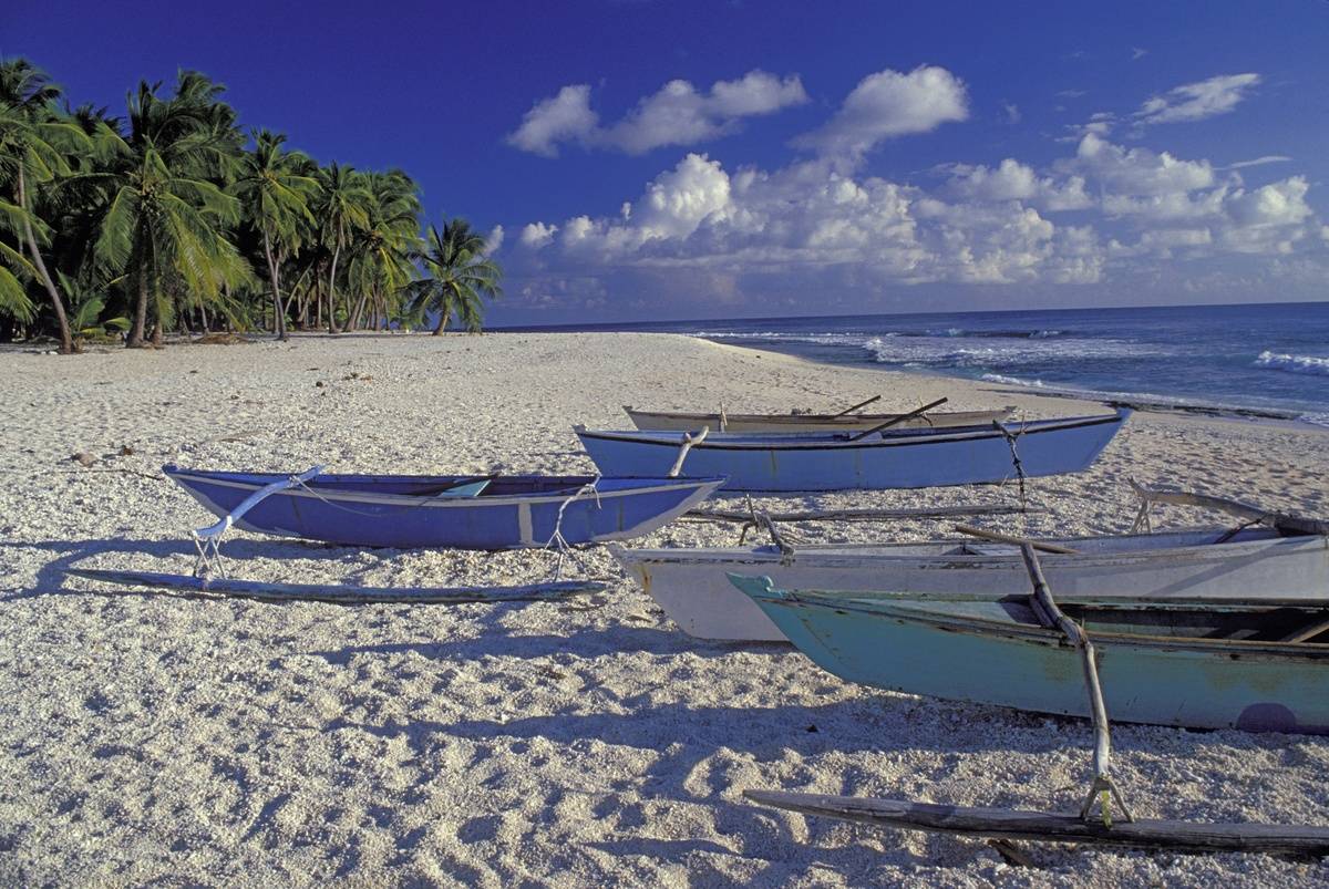 Outrigger Canoes On white sand Beach