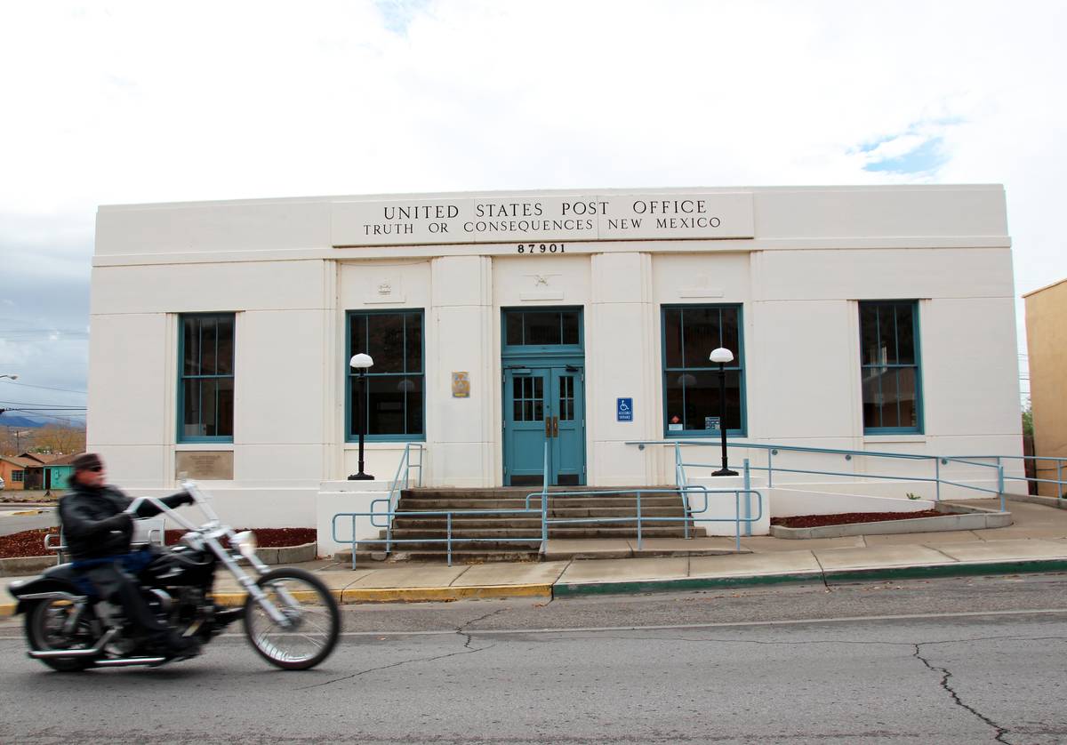 A motorcylce rides past the post office in the town of Truth or Consequences, New Mexico