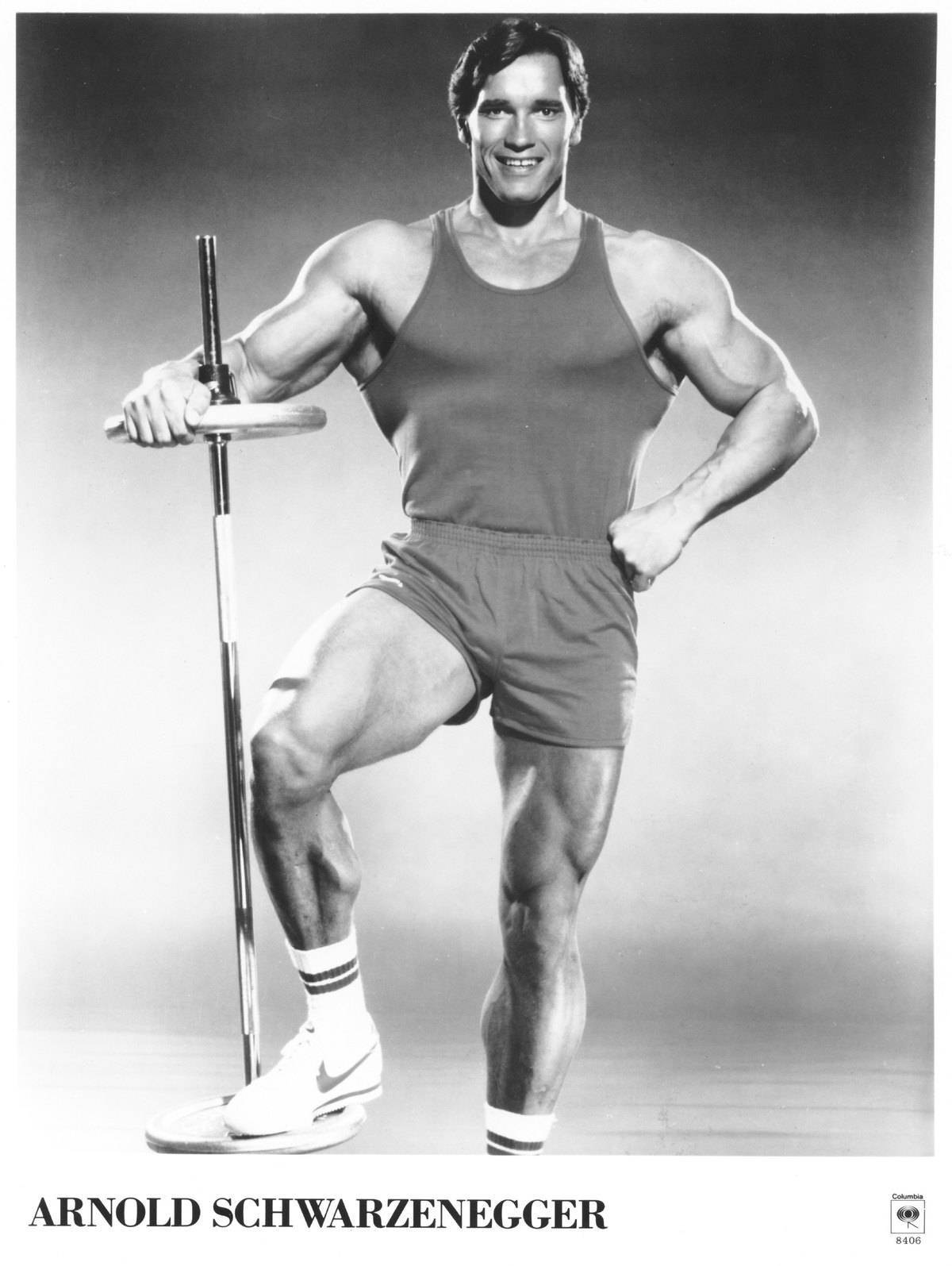 Arnold Schwarzenegger with workout equipment
