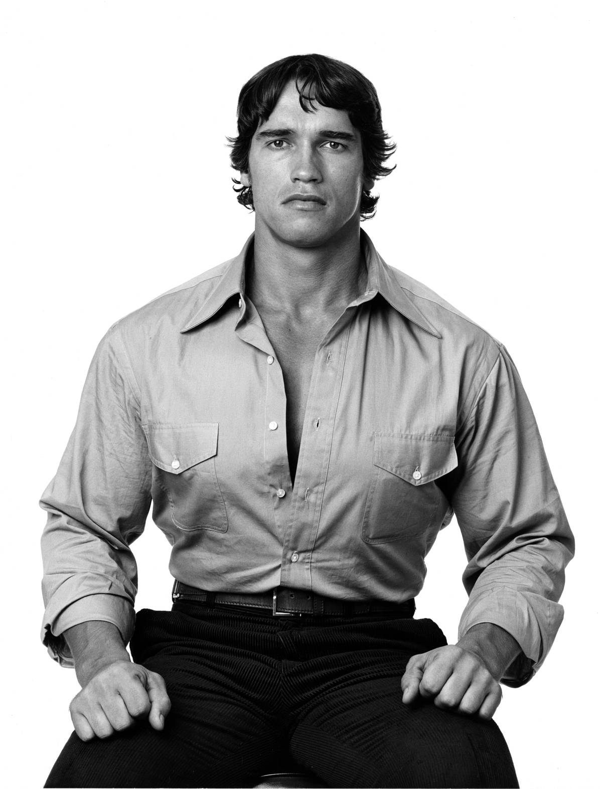 Arnold Schwarzenegger sitting down