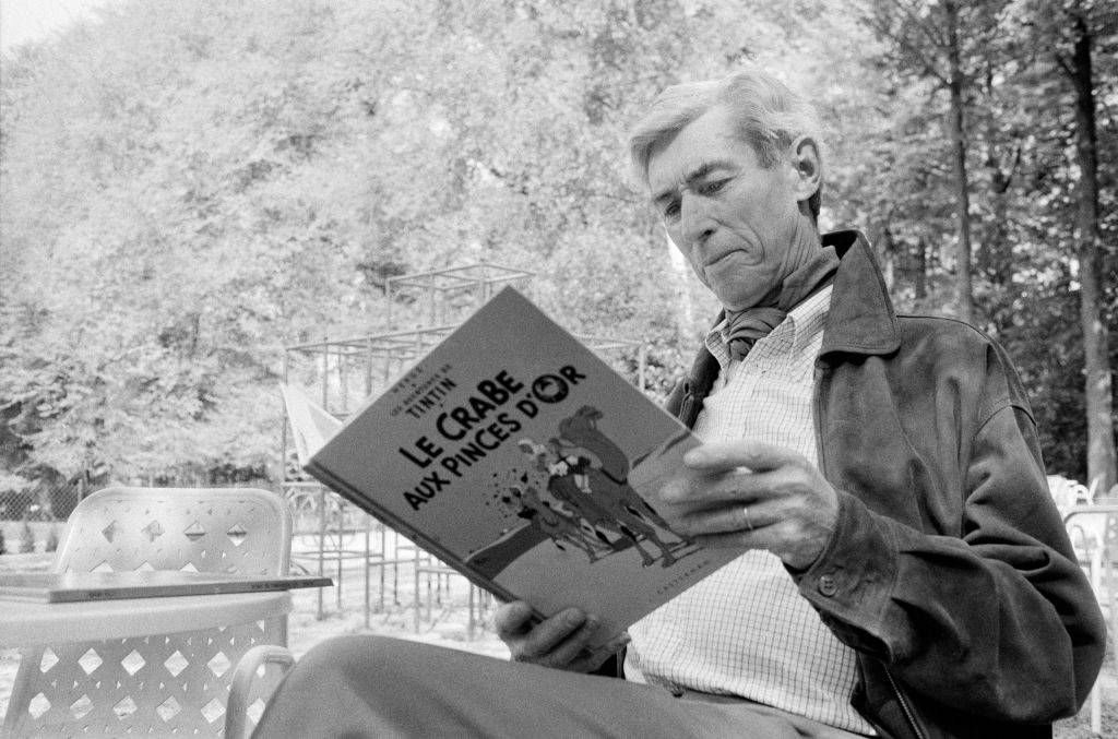 hergé reading a book of his work
