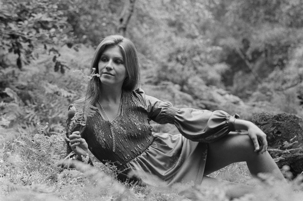 A female fashion model wearing pleated top short dress with bishop sleeves