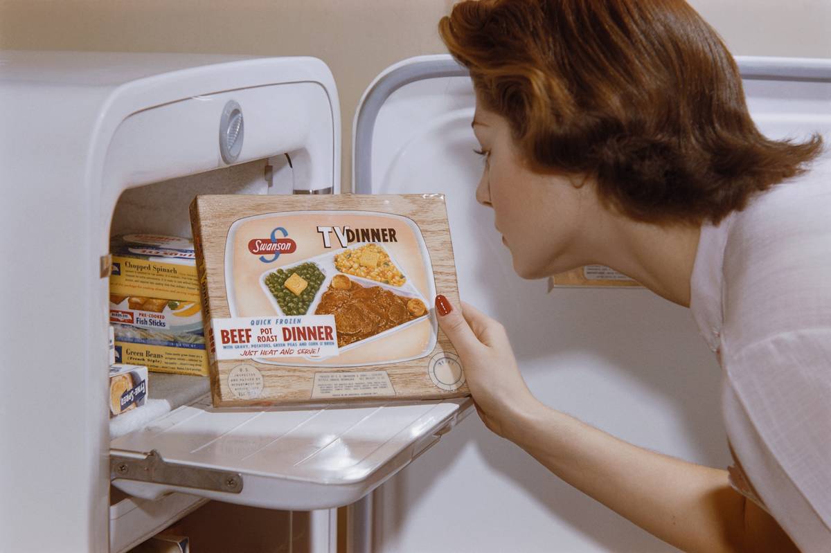 Woman Choosing TV Dinner from Freezer
