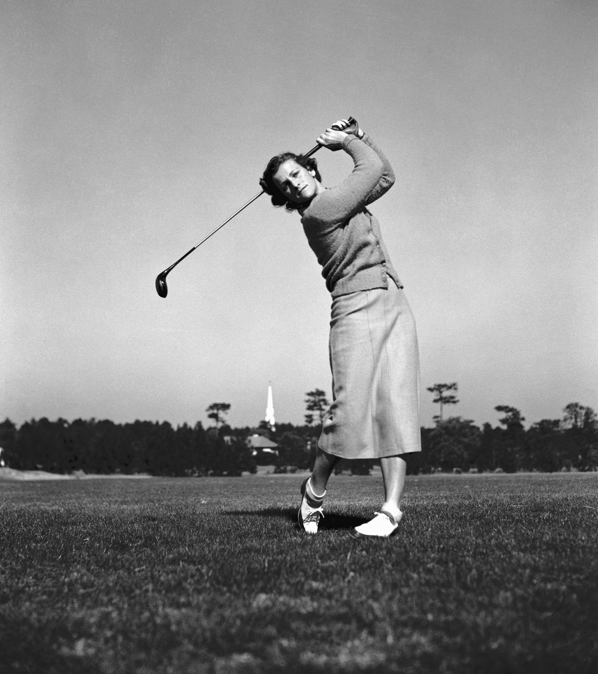 Babe Didrikson Zaharias swings a golf club.