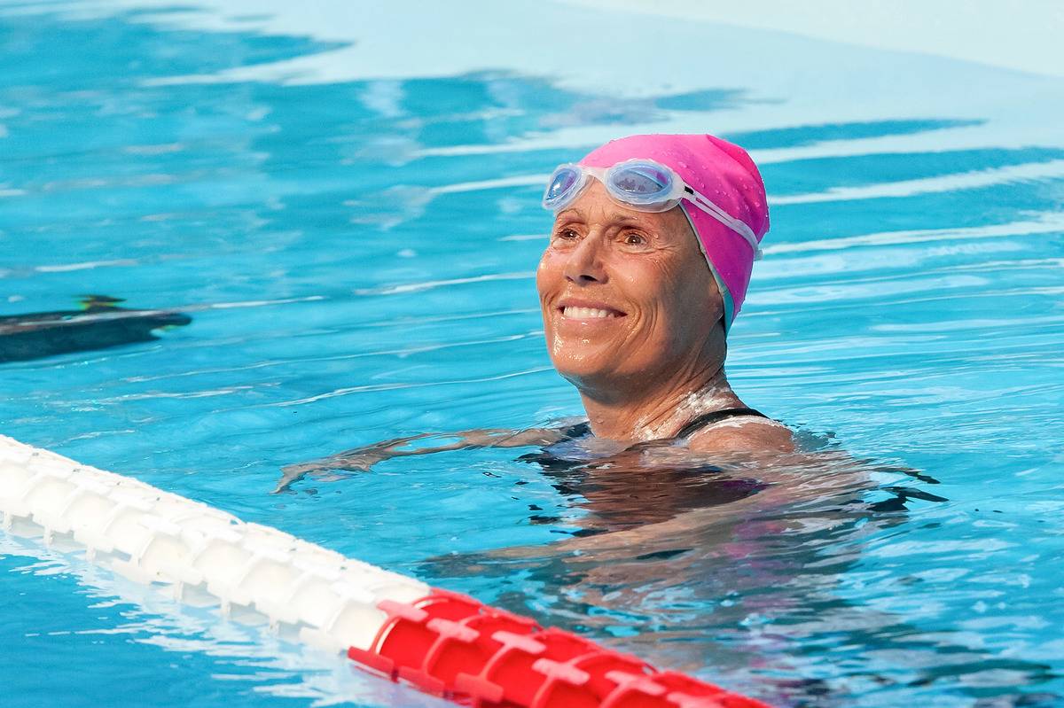 Diana Nyad smiles in a swimming pool.