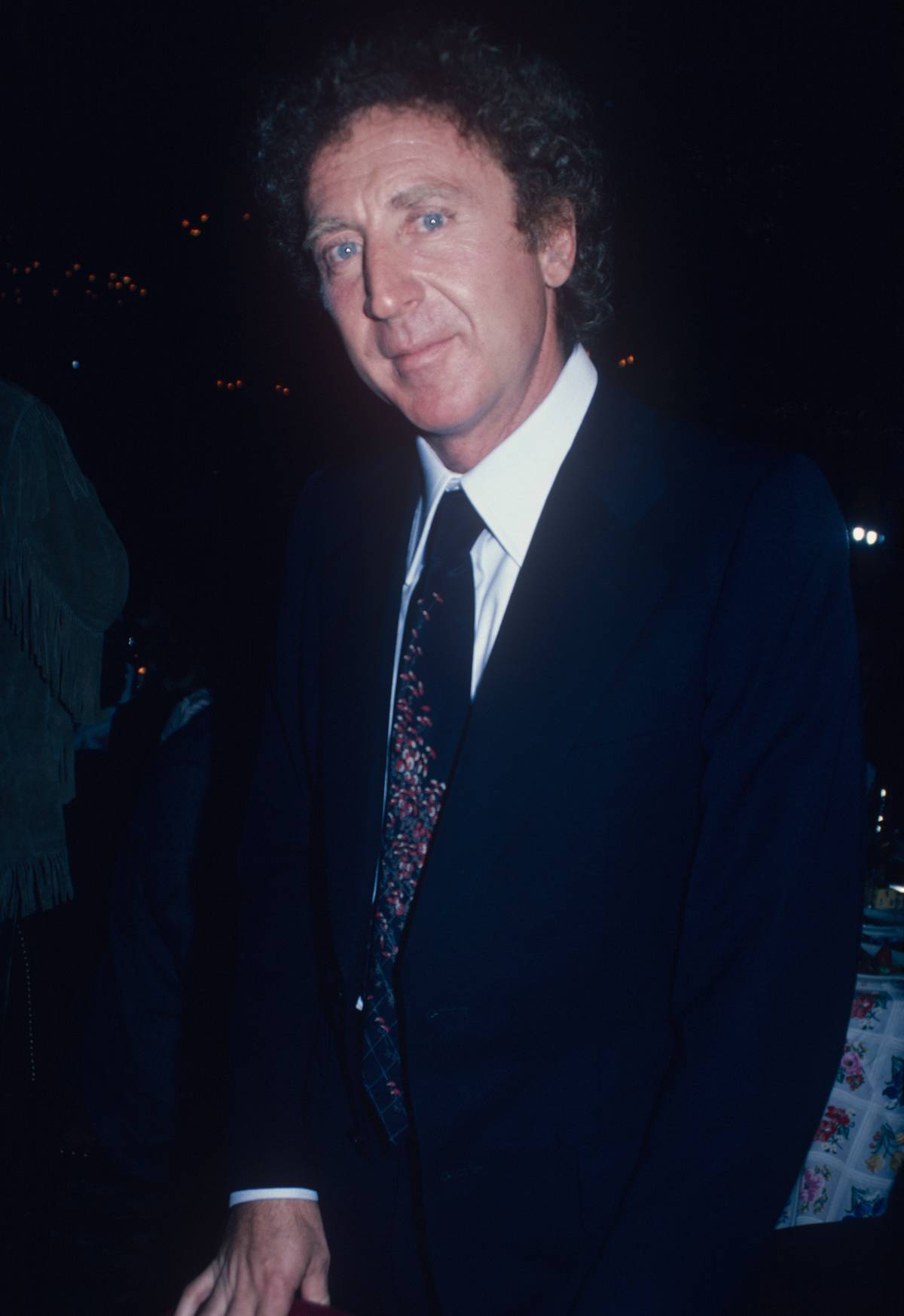 Gene Wilder posing in a suit having his picture taken