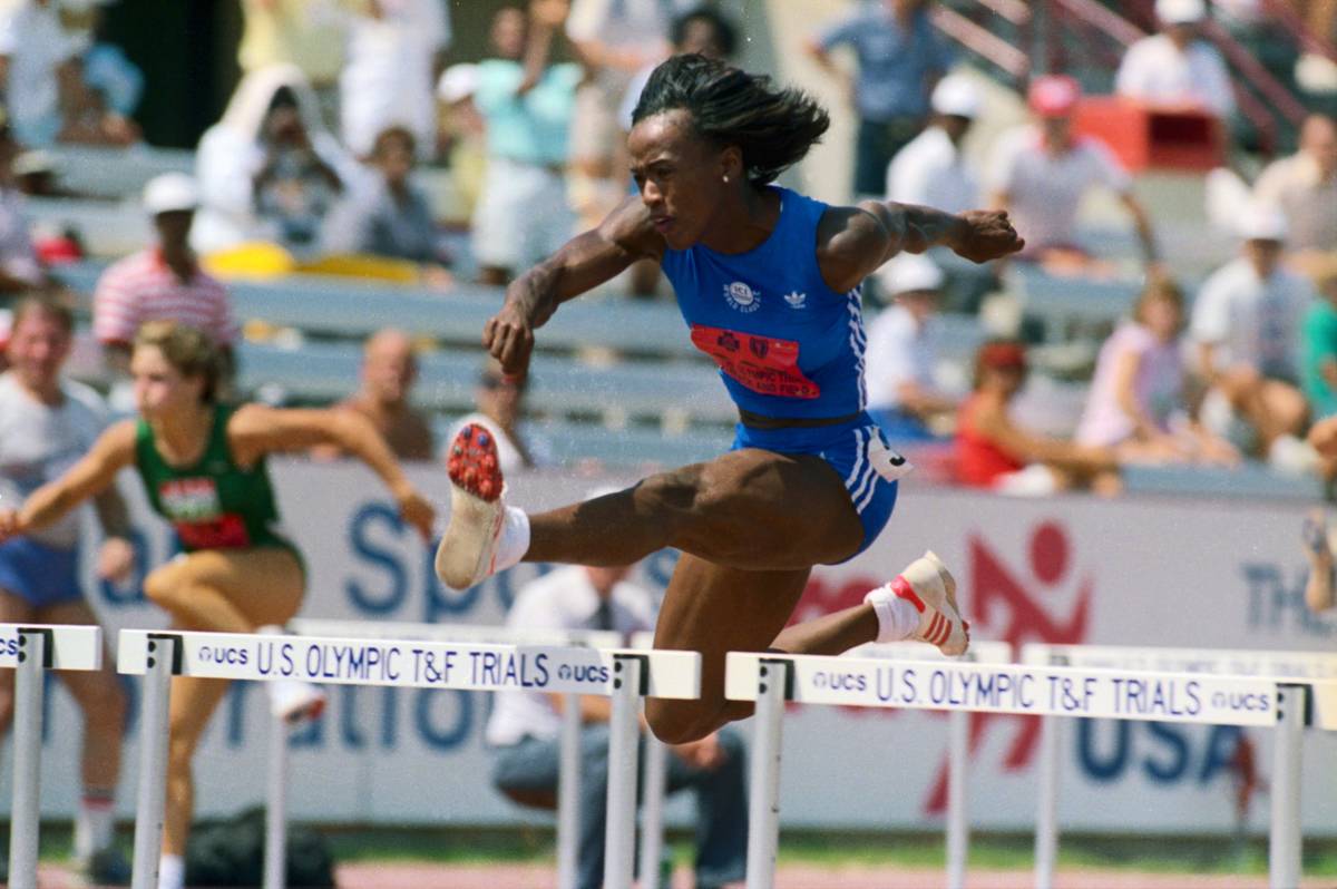 Jackie Joyner jumping hurdles.